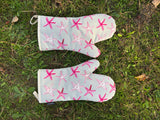 Oven mitts on grass
