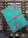 Oh so bright pink octopus tea towel folded on cooker